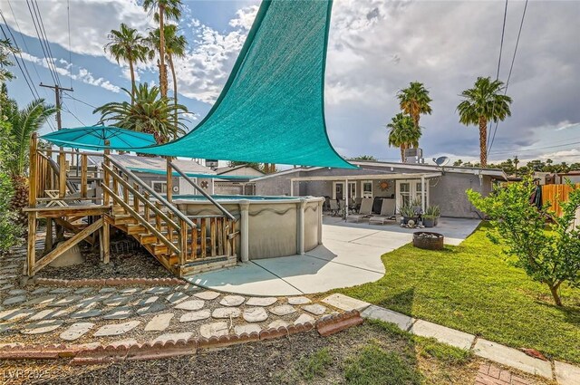 5217 Champions Ave, Las Vegas, NV 89142 - rear view of house with a jacuzzi and a patio area