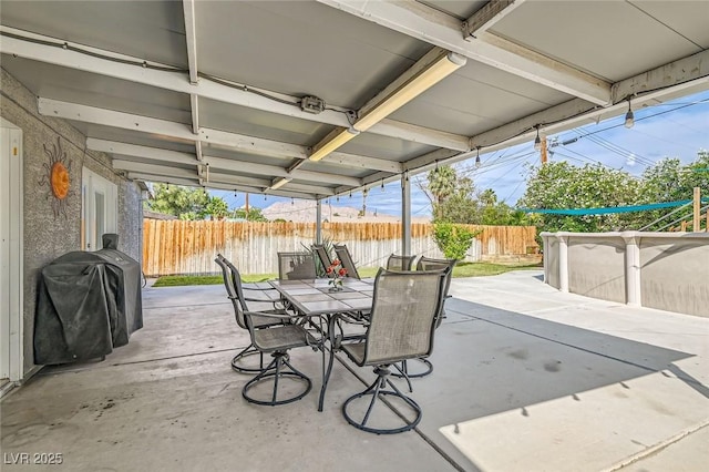5217 Champions Ave, Las Vegas, NV 89142 - fenced backyard with outdoor dining area, a grill, and a patio