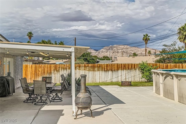 5217 Champions Ave, Las Vegas, NV 89142 - fenced backyard featuring grilling area, outdoor dining area, a patio area, and a fire pit