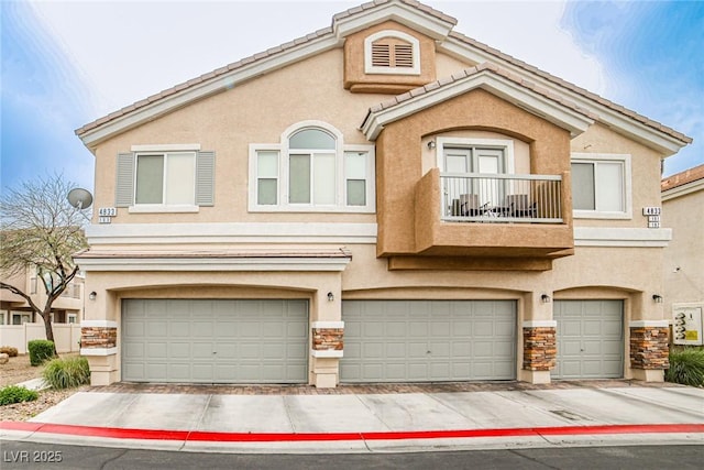 4833 Straight Flush Dr Unit 103, Las Vegas, NV 89122 - multi unit property featuring an attached garage, stucco siding, stone siding, and a balcony