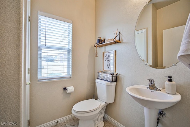 4833 Straight Flush Dr Unit 103, Las Vegas, NV 89122 - bathroom featuring toilet, plenty of natural light, and baseboards