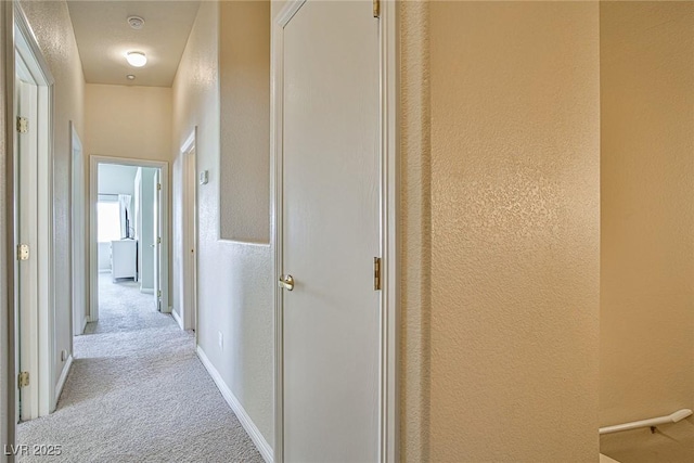 4833 Straight Flush Dr Unit 103, Las Vegas, NV 89122 - corridor featuring light colored carpet, a textured wall, and baseboards