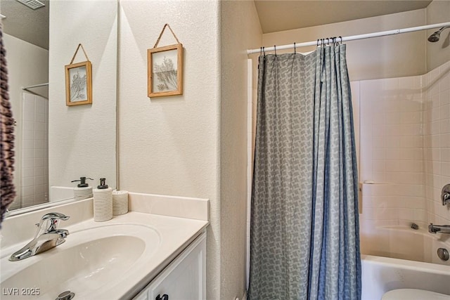 4833 Straight Flush Dr Unit 103, Las Vegas, NV 89122 - full bathroom featuring vanity, shower / bath combo, a textured wall, and toilet