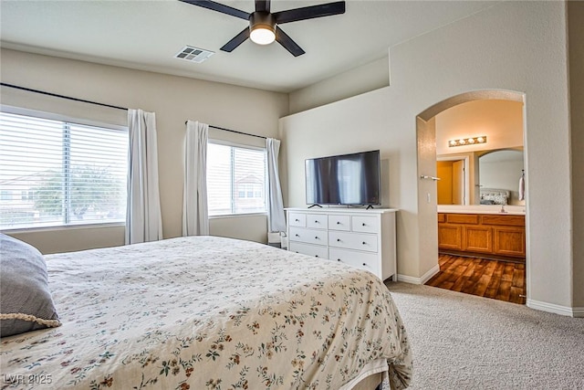 4833 Straight Flush Dr Unit 103, Las Vegas, NV 89122 - bedroom with arched walkways, dark carpet, baseboards, and a ceiling fan