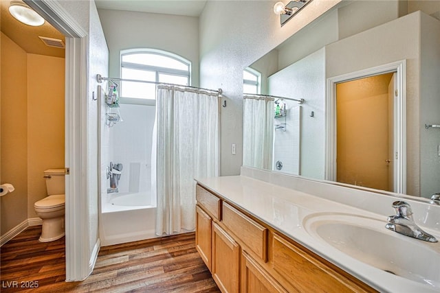 4833 Straight Flush Dr Unit 103, Las Vegas, NV 89122 - bathroom featuring toilet, wood finished floors, vanity, and shower / bath combo