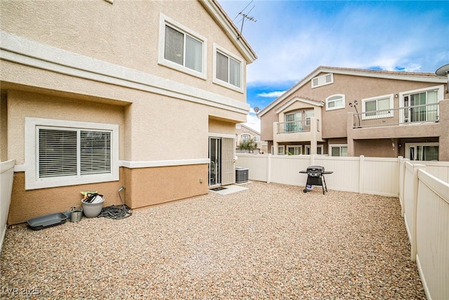 4833 Straight Flush Dr Unit 103, Las Vegas, NV 89122 - back of property with a fenced backyard, stucco siding, a patio area, and central AC unit