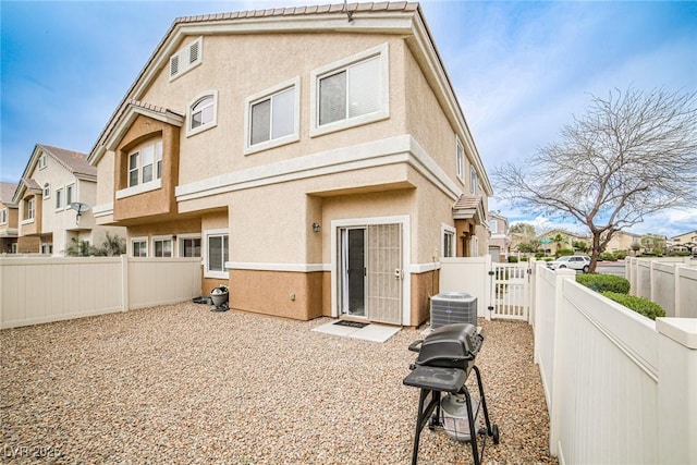 4833 Straight Flush Dr Unit 103, Las Vegas, NV 89122 - back of house with stucco siding, a fenced backyard, central AC, and a residential view