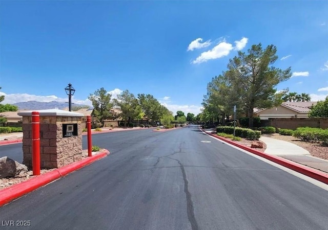 8616 Willow Cabin St, Las Vegas, NV 89131 - view of asphalt road with sidewalks, curbs, and street lighting