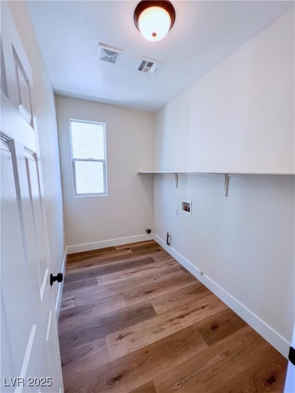 8616 Willow Cabin St, Las Vegas, NV 89131 - laundry area featuring gas dryer hookup, washer hookup, baseboards, and wood finished floors