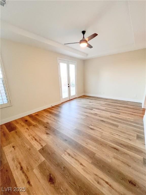 8616 Willow Cabin St, Las Vegas, NV 89131 - empty room with french doors, healthy amount of natural light, light wood finished floors, and ceiling fan
