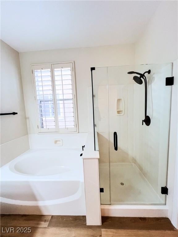8616 Willow Cabin St, Las Vegas, NV 89131 - bathroom with a garden tub, a shower stall, and wood finished floors