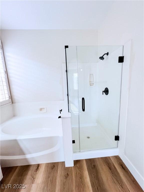 8616 Willow Cabin St, Las Vegas, NV 89131 - full bathroom featuring wood finished floors, a shower stall, and a garden tub
