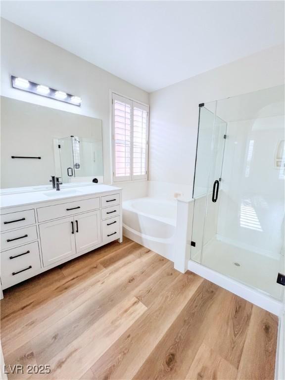 8616 Willow Cabin St, Las Vegas, NV 89131 - full bath with vanity, a bath, wood finished floors, and a shower stall