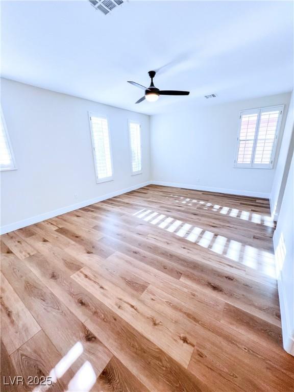 8616 Willow Cabin St, Las Vegas, NV 89131 - spare room featuring wood finished floors, ceiling fan, and baseboards