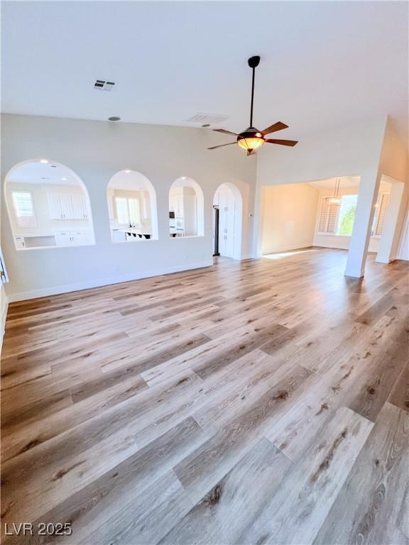 8616 Willow Cabin St, Las Vegas, NV 89131 - unfurnished living room with a ceiling fan, wood finished floors, and baseboards