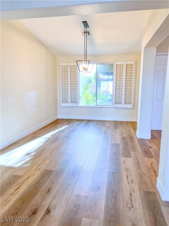 8616 Willow Cabin St, Las Vegas, NV 89131 - unfurnished dining area featuring baseboards and light wood-style floors