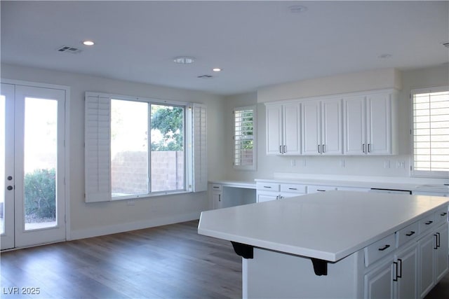 8616 Willow Cabin St, Las Vegas, NV 89131 - kitchen with light countertops, white cabinets, recessed lighting, light wood-type flooring, and a kitchen island