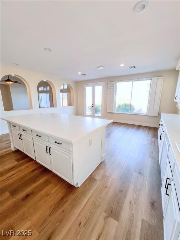 8616 Willow Cabin St, Las Vegas, NV 89131 - kitchen featuring light wood-style floors, white cabinetry, light countertops, recessed lighting, and french doors