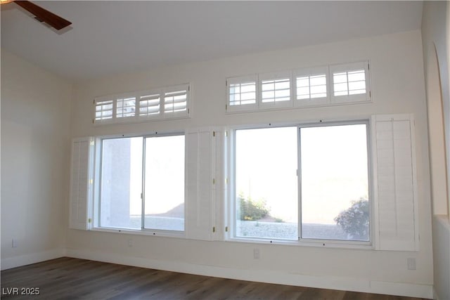 8616 Willow Cabin St, Las Vegas, NV 89131 - empty room with dark wood-type flooring, plenty of natural light, baseboards, and a towering ceiling