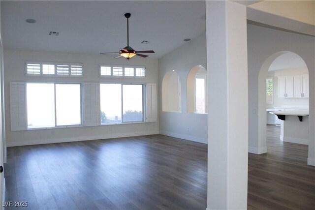 8616 Willow Cabin St, Las Vegas, NV 89131 - unfurnished room featuring ceiling fan, dark wood finished floors, plenty of natural light, and arched walkways