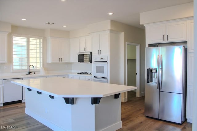 8616 Willow Cabin St, Las Vegas, NV 89131 - kitchen with appliances with stainless steel finishes, a sink, a kitchen island, white cabinetry, and recessed lighting