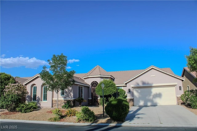 8616 Willow Cabin St, Las Vegas, NV 89131 - single story home featuring stone siding, stucco siding, a garage, driveway, and a tiled roof