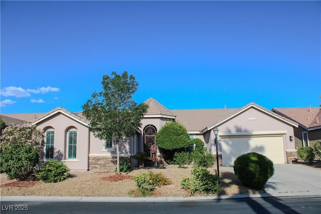 8616 Willow Cabin St, Las Vegas, NV 89131 - ranch-style house featuring stucco siding, an attached garage, concrete driveway, a tiled roof, and stone siding