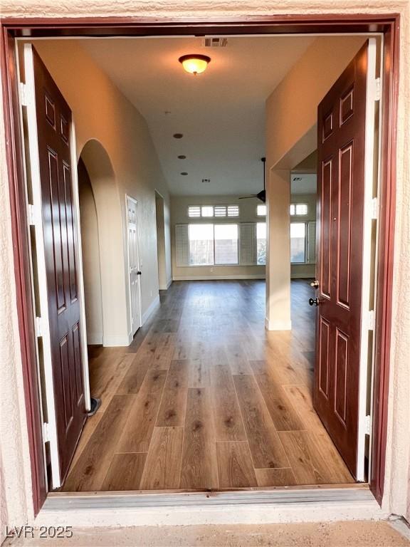8616 Willow Cabin St, Las Vegas, NV 89131 - hallway featuring wood finished floors and arched walkways