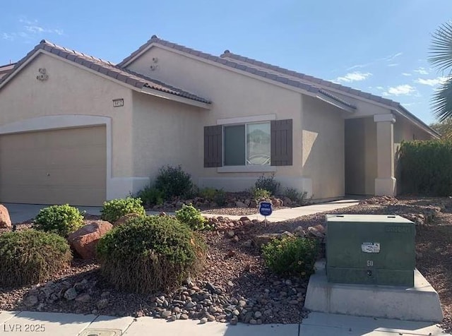 6412 Starling Mesa St, North Las Vegas, NV 89086 - ranch-style home with a garage, stucco siding, and a tile roof