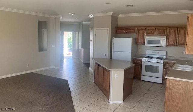 6412 Starling Mesa St, North Las Vegas, NV 89086 - kitchen featuring white appliances, light tile patterned flooring, a kitchen island, crown molding, and baseboards