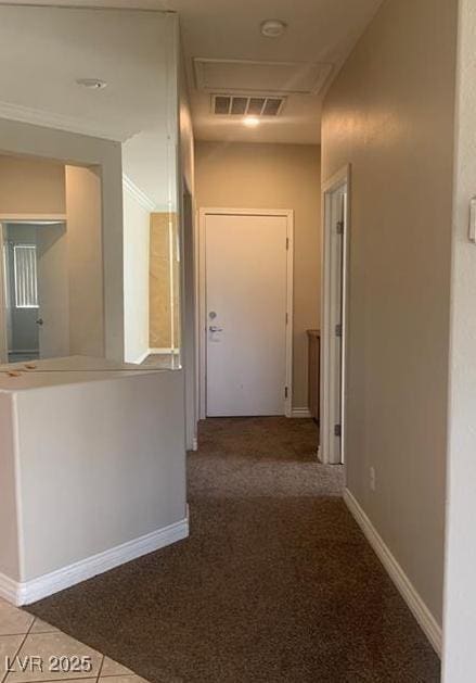 6412 Starling Mesa St, North Las Vegas, NV 89086 - corridor with attic access, baseboards, tile patterned floors, and carpet flooring