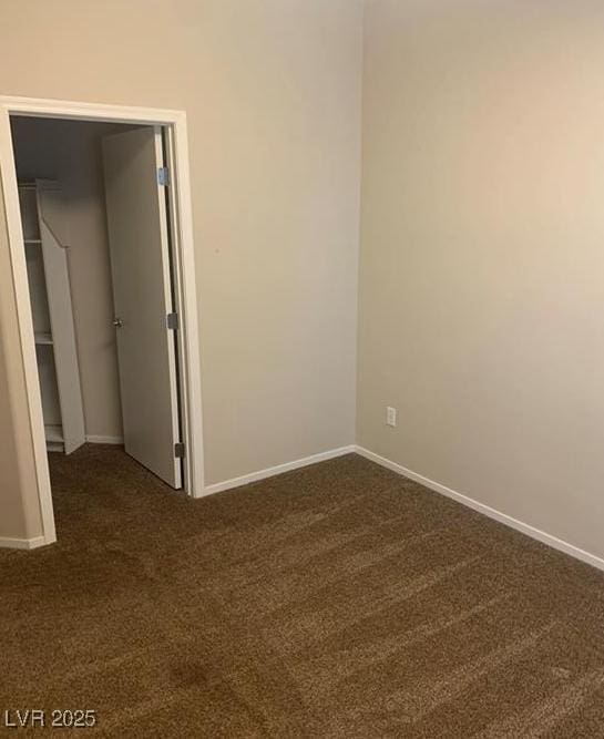 6412 Starling Mesa St, North Las Vegas, NV 89086 - empty room with dark colored carpet and baseboards