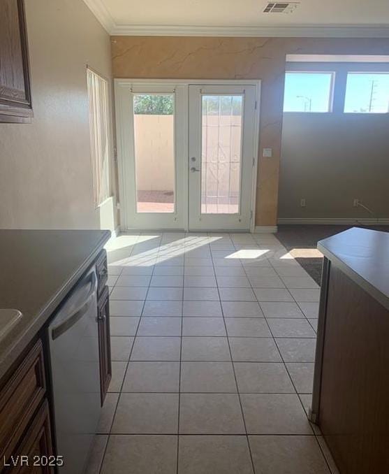 6412 Starling Mesa St, North Las Vegas, NV 89086 - doorway to outside featuring crown molding, light tile patterned flooring, and baseboards