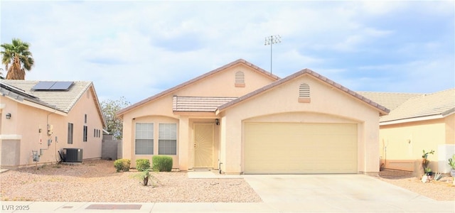 5112 Foggia Ave, Las Vegas, NV 89130 - view of front facade with a garage, stucco siding, driveway, cooling unit, and roof mounted solar panels