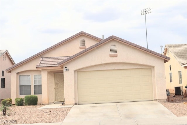5112 Foggia Ave, Las Vegas, NV 89130 - view of front of house featuring stucco siding, concrete driveway, an attached garage, and a tiled roof
