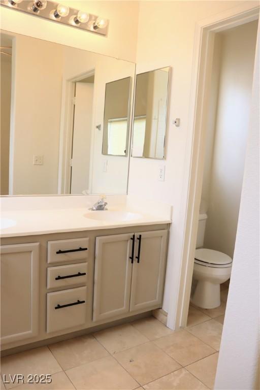 5112 Foggia Ave, Las Vegas, NV 89130 - full bathroom featuring tile patterned floors, double vanity, and toilet