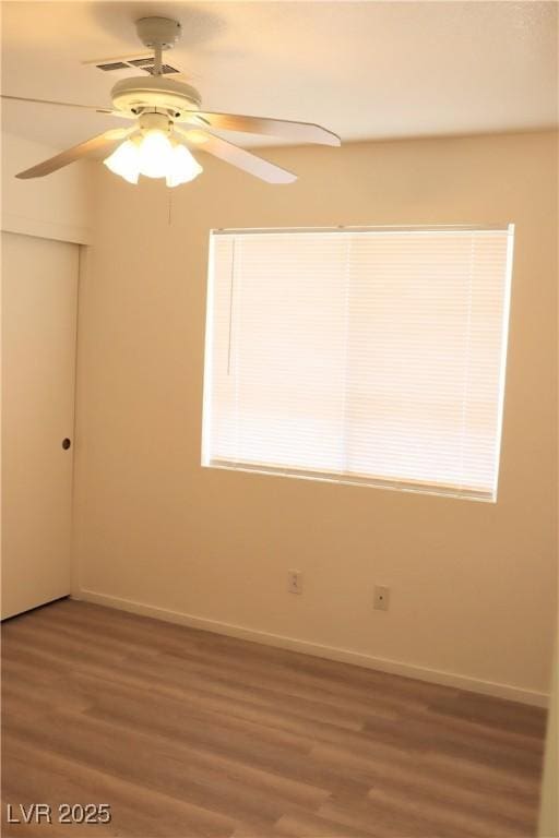 5112 Foggia Ave, Las Vegas, NV 89130 - unfurnished room with a ceiling fan, wood finished floors, baseboards, and plenty of natural light