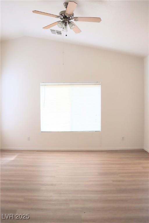 5112 Foggia Ave, Las Vegas, NV 89130 - unfurnished room featuring light wood-style floors, a ceiling fan, vaulted ceiling, and baseboards
