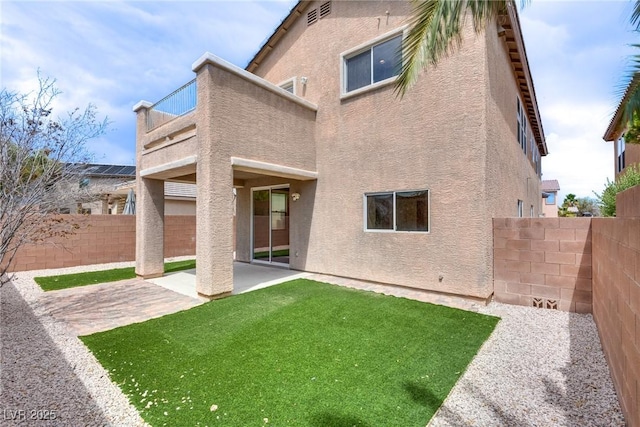 8745 Dodds Canyon St, Las Vegas, NV 89131 - back of property with a balcony, stucco siding, a fenced backyard, and a patio