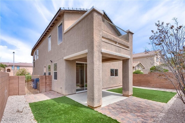 8745 Dodds Canyon St, Las Vegas, NV 89131 - back of property with stucco siding, a fenced backyard, a patio area, and a balcony