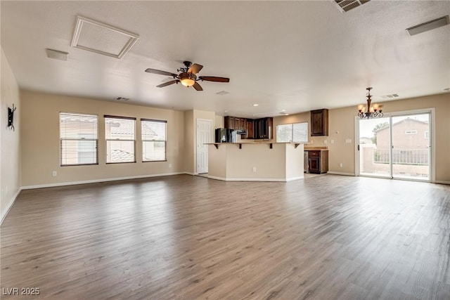 8745 Dodds Canyon St, Las Vegas, NV 89131 - unfurnished living room featuring healthy amount of natural light, dark wood-style floors, a chandelier, and ceiling fan