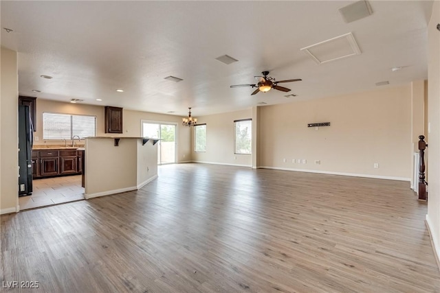 8745 Dodds Canyon St, Las Vegas, NV 89131 - unfurnished living room with light wood finished floors, a ceiling fan, a chandelier, and recessed lighting