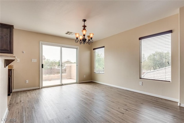 8745 Dodds Canyon St, Las Vegas, NV 89131 - unfurnished living room featuring a chandelier and light wood-style floors