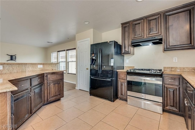 8745 Dodds Canyon St, Las Vegas, NV 89131 - kitchen featuring black fridge with ice dispenser, stainless steel range with gas stovetop, under cabinet range hood, dark brown cabinets, and recessed lighting