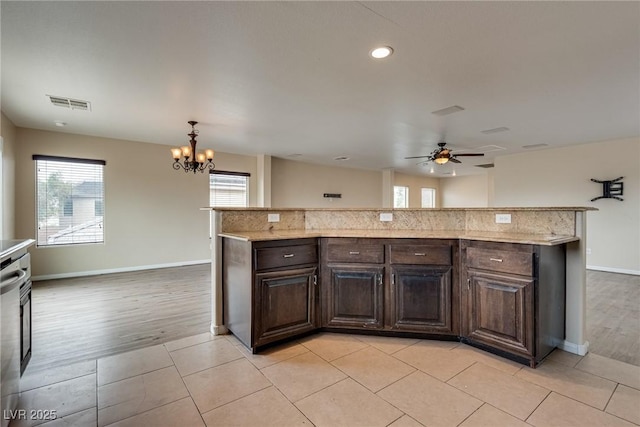8745 Dodds Canyon St, Las Vegas, NV 89131 - kitchen featuring a chandelier, dark brown cabinetry, a ceiling fan, light stone countertops, and recessed lighting