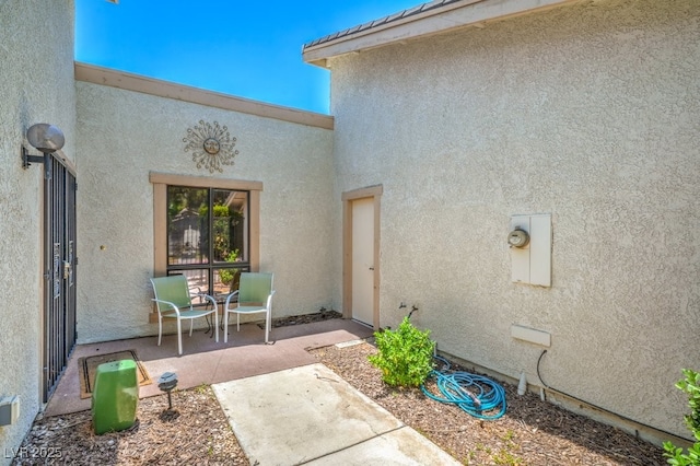5713 Whiteridge Ave, Las Vegas, NV 89107 - view of exterior entry featuring stucco siding and a patio