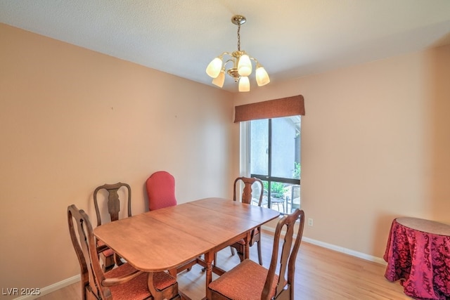 5713 Whiteridge Ave, Las Vegas, NV 89107 - dining room with a chandelier, baseboards, and light wood finished floors