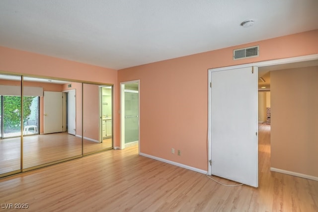 5713 Whiteridge Ave, Las Vegas, NV 89107 - unfurnished bedroom featuring wood finished floors, baseboards, and ensuite bathroom