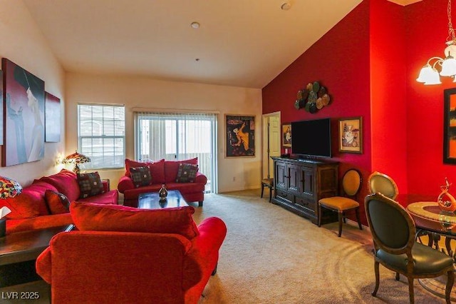 8777 Maule Ave Unit 3116, Las Vegas, NV 89148 - carpeted living room with lofted ceiling, a chandelier, and baseboards