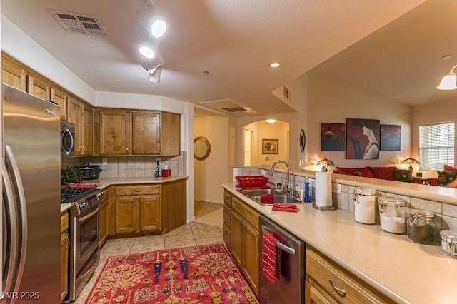 8777 Maule Ave Unit 3116, Las Vegas, NV 89148 - kitchen with stainless steel appliances, a sink, arched walkways, decorative backsplash, and light countertops